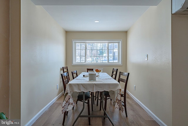 dining space with light hardwood / wood-style floors