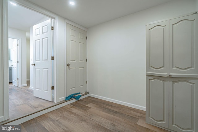 corridor with light hardwood / wood-style floors