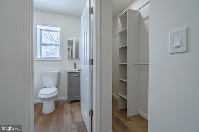 bathroom featuring vanity, hardwood / wood-style floors, and toilet