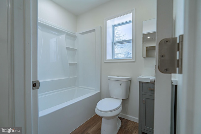 full bathroom featuring wood-type flooring, toilet,  shower combination, and vanity