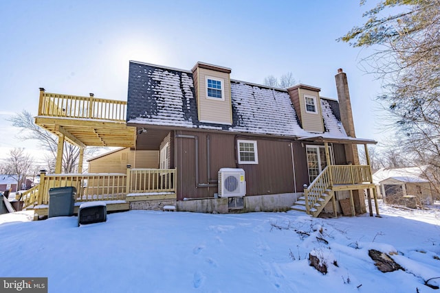 snow covered house with ac unit