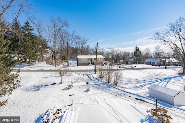 view of yard layered in snow