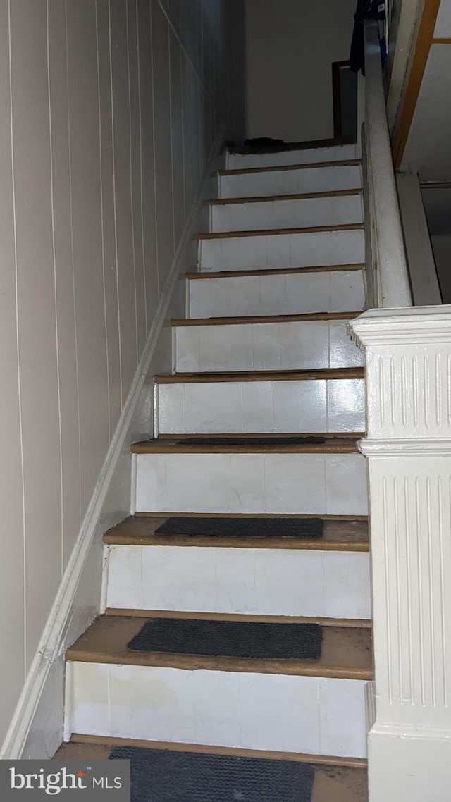 staircase with wooden walls