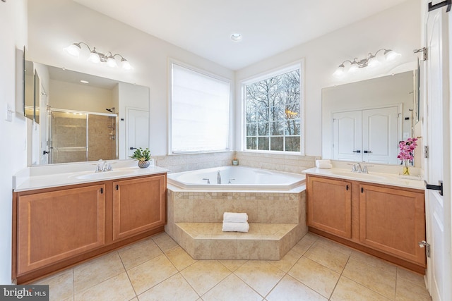 bathroom featuring two vanities, a sink, a bath, and a shower stall