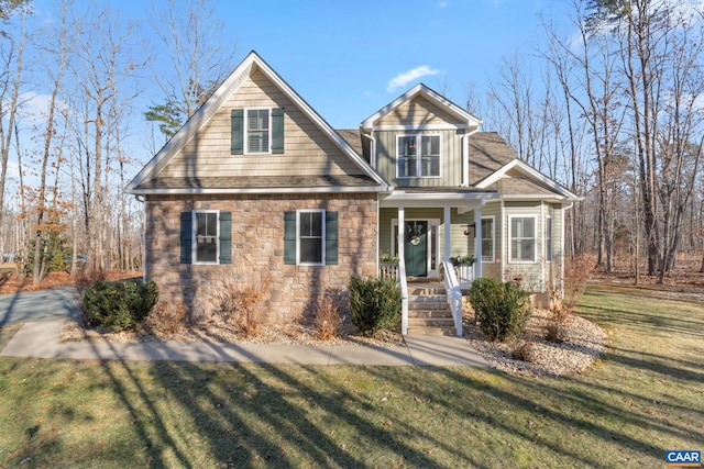 view of front of property with covered porch and a front yard