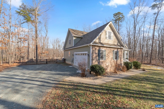 view of side of home with a yard and a garage