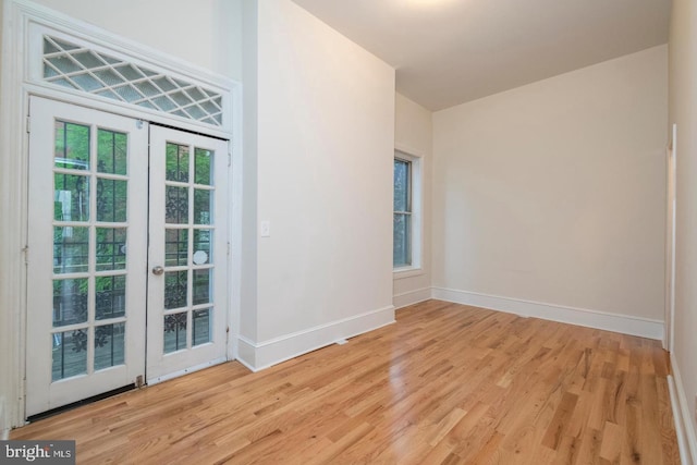 interior space with light wood-type flooring and french doors