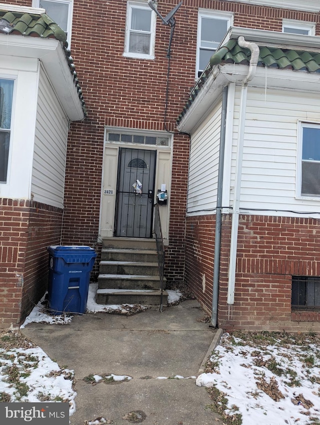 view of snow covered property entrance