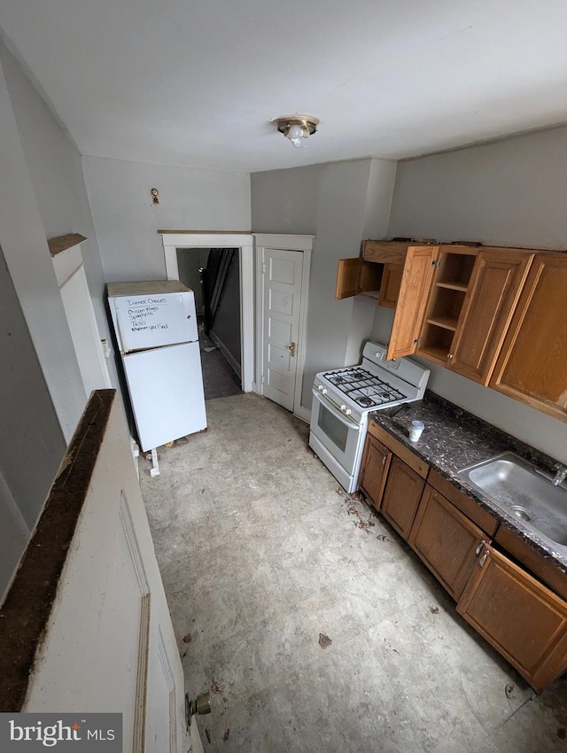 kitchen with sink and white appliances