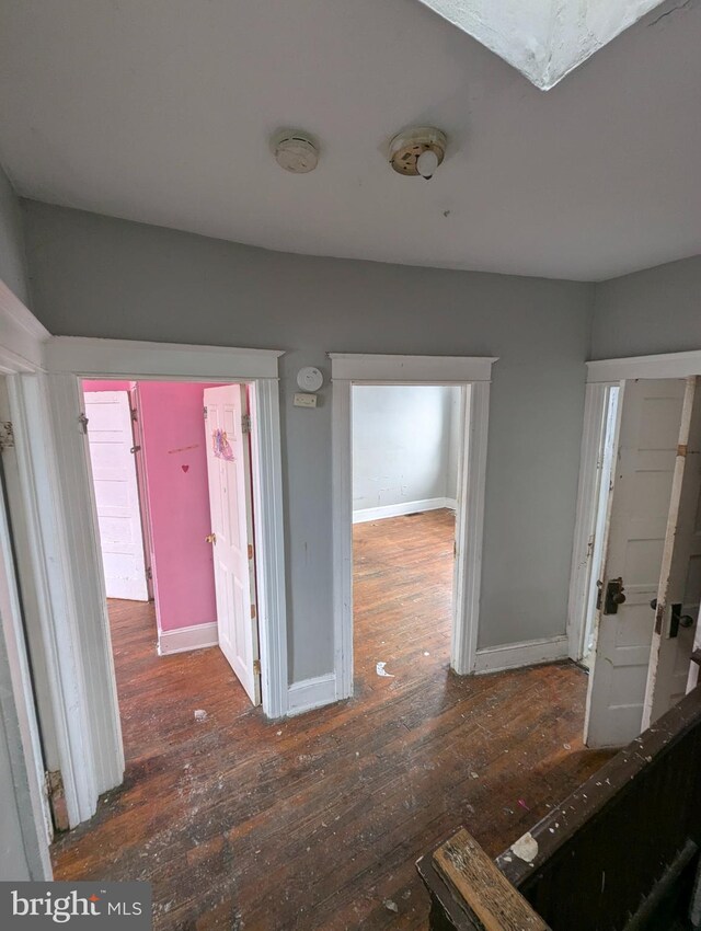 hallway with dark wood-type flooring