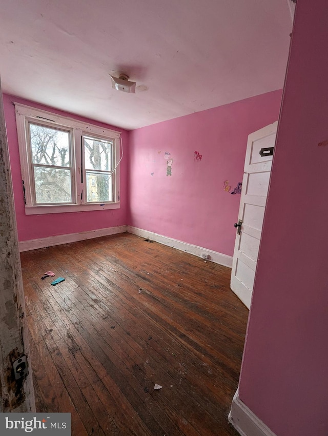 empty room with dark hardwood / wood-style floors