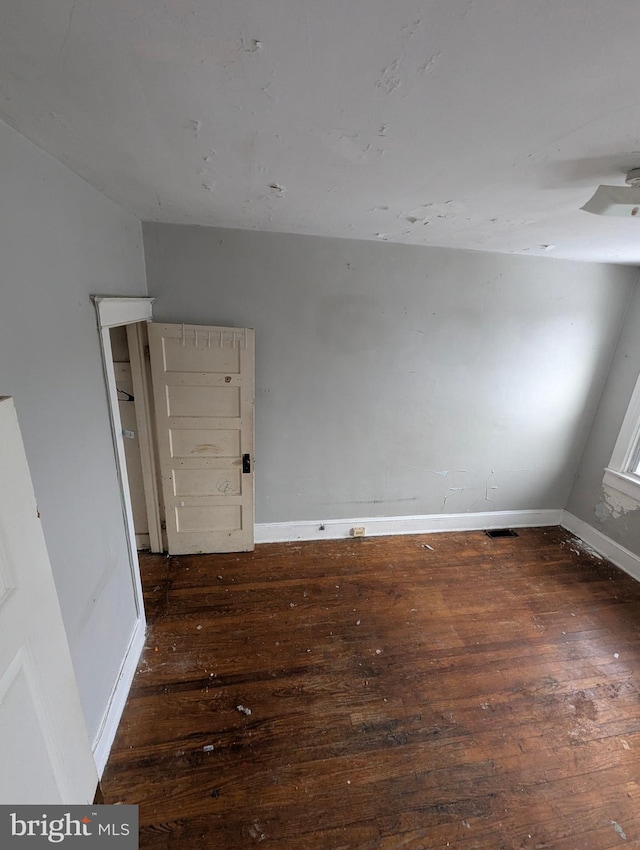 empty room featuring dark wood-type flooring