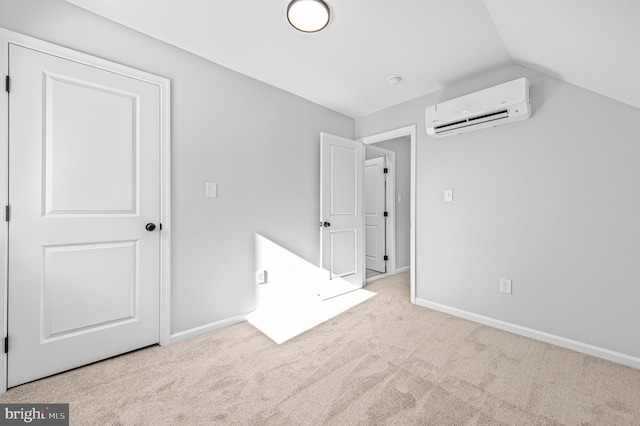 unfurnished bedroom with an AC wall unit, light colored carpet, and lofted ceiling