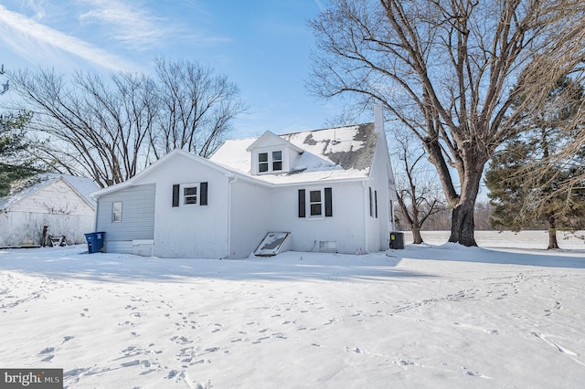 view of snow covered rear of property