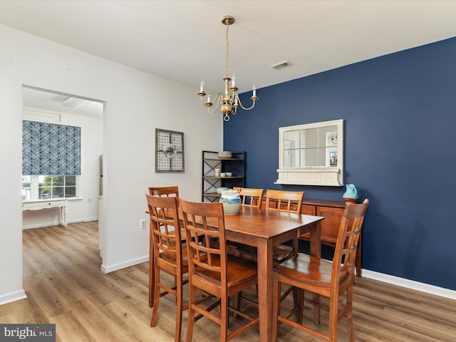 dining room featuring an inviting chandelier and wood-type flooring