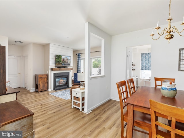 dining space with a notable chandelier and light wood-type flooring