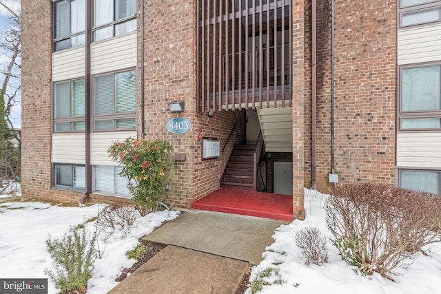 view of snow covered property entrance