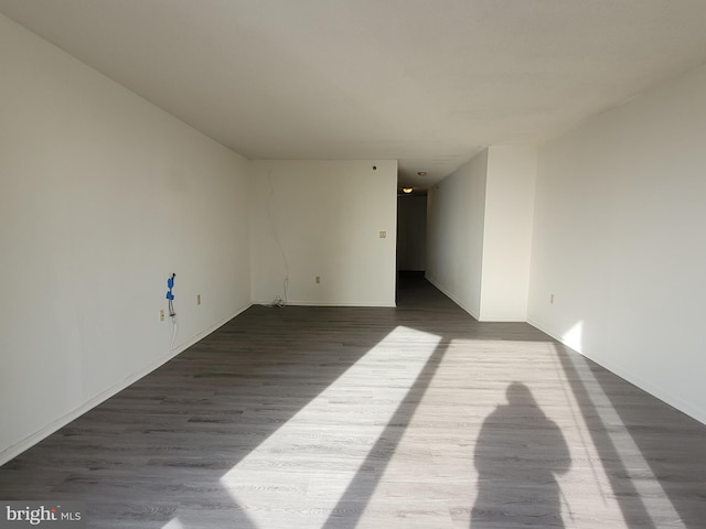 empty room with hardwood / wood-style flooring