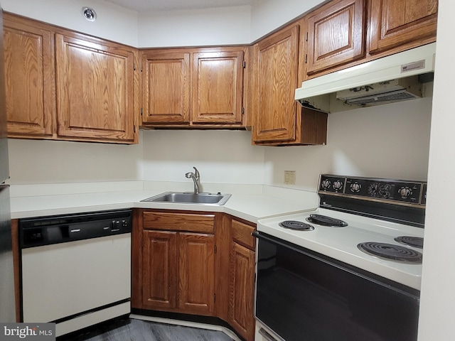 kitchen featuring dark hardwood / wood-style floors, dishwasher, sink, and range with electric stovetop