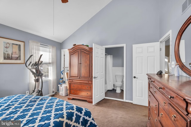 bedroom featuring high vaulted ceiling, light colored carpet, and connected bathroom