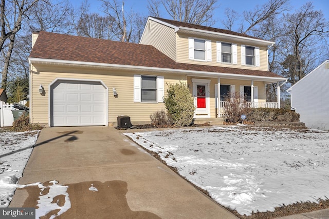 view of property featuring a garage and covered porch