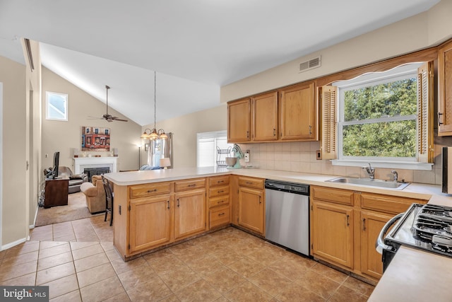 kitchen featuring plenty of natural light, sink, dishwasher, and kitchen peninsula