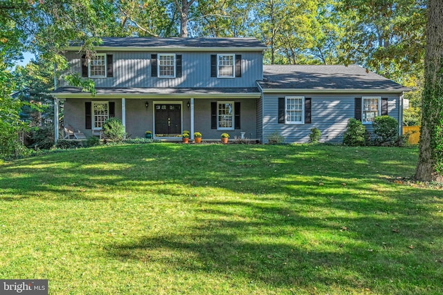 view of front facade with a front lawn and covered porch