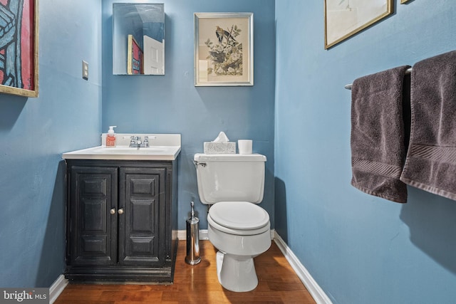 bathroom with vanity, hardwood / wood-style flooring, and toilet