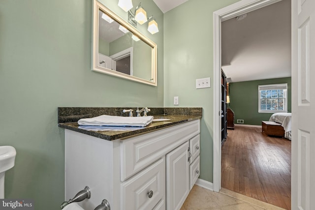 bathroom featuring hardwood / wood-style flooring and vanity