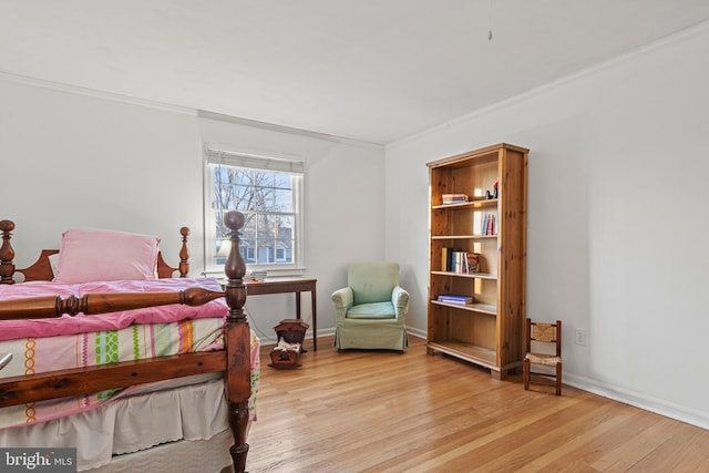 bedroom with ornamental molding and light wood-type flooring