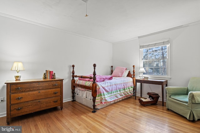 bedroom featuring light hardwood / wood-style flooring and ornamental molding