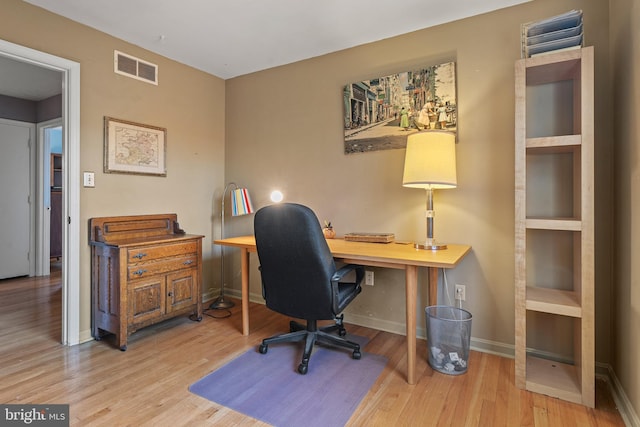 office with light hardwood / wood-style flooring