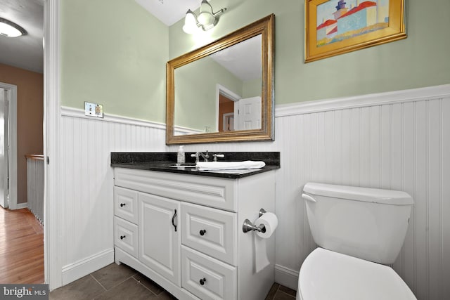 bathroom featuring vanity, tile patterned floors, and toilet