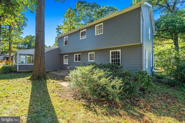 back of property featuring a yard