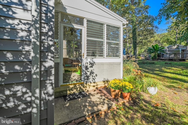 view of side of home with a yard