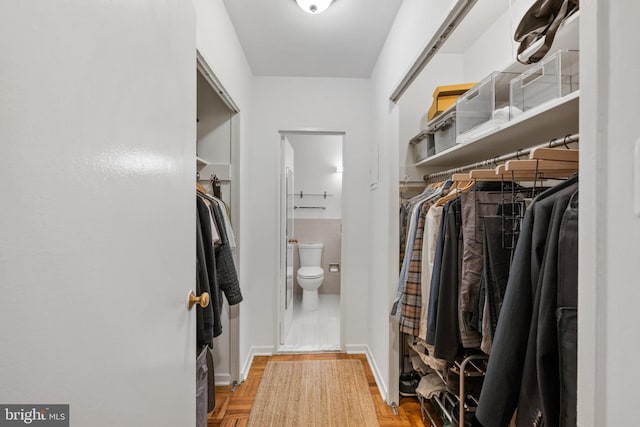 spacious closet with parquet floors