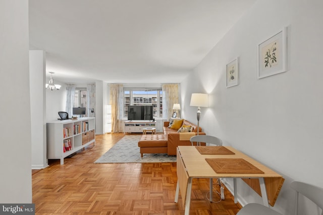 living room with light parquet flooring and a chandelier