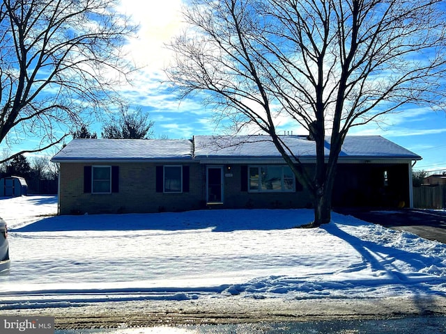 single story home featuring brick siding