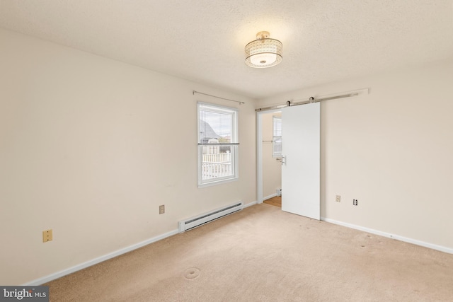 unfurnished room with baseboards, a baseboard heating unit, a textured ceiling, and carpet flooring