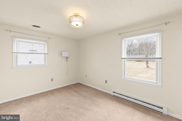 empty room featuring a textured ceiling, light carpet, a baseboard radiator, and visible vents