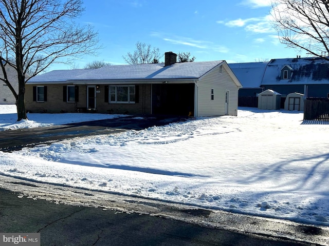 view of front of house with an outbuilding, a chimney, and a storage unit