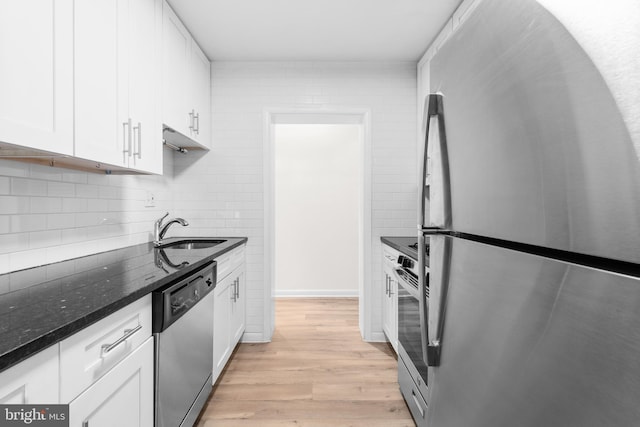 kitchen featuring stainless steel appliances, sink, light hardwood / wood-style flooring, and white cabinets