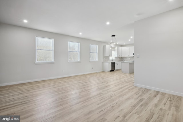 unfurnished living room with light wood-type flooring