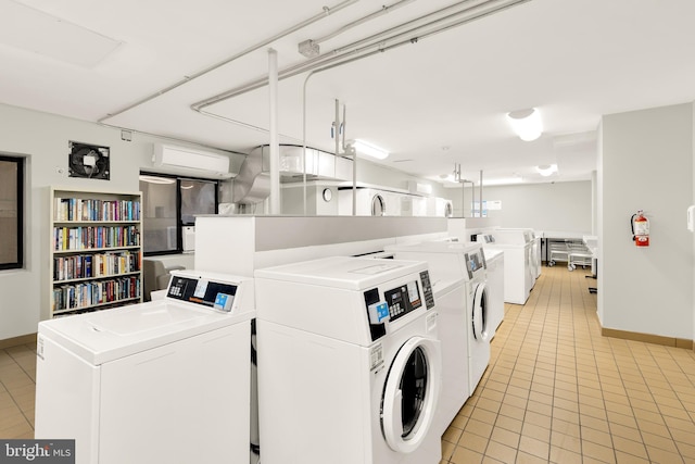 laundry room with light tile patterned floors and washing machine and clothes dryer