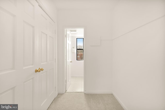 hallway featuring light carpet