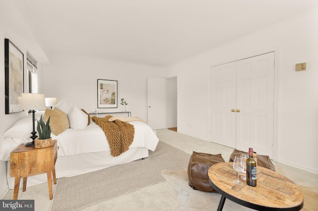 bedroom with light carpet and a closet