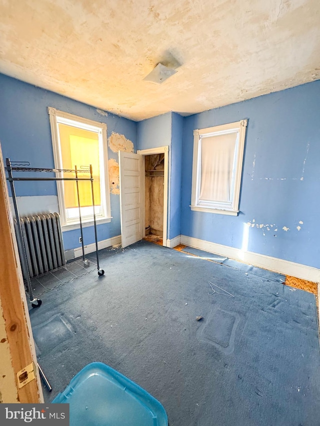 unfurnished bedroom featuring radiator