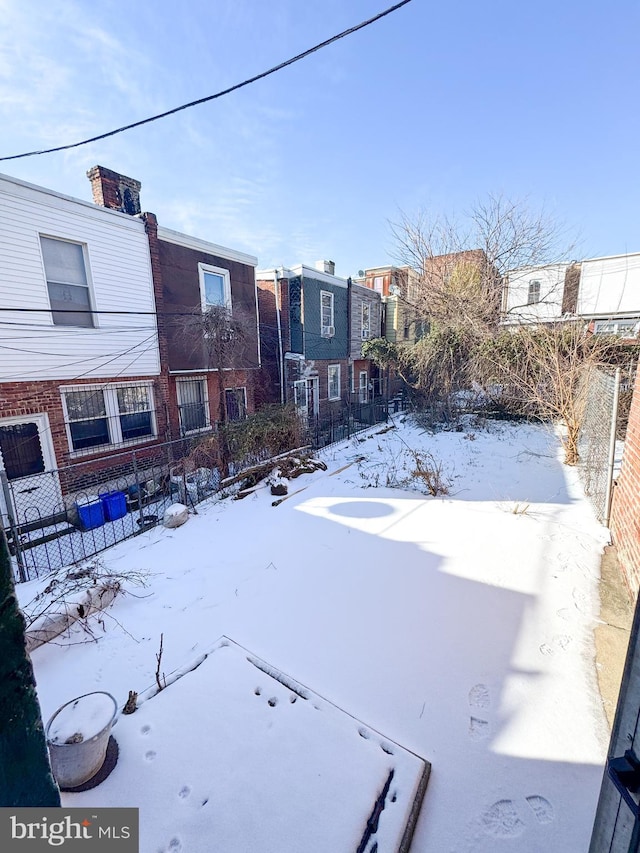 view of yard layered in snow