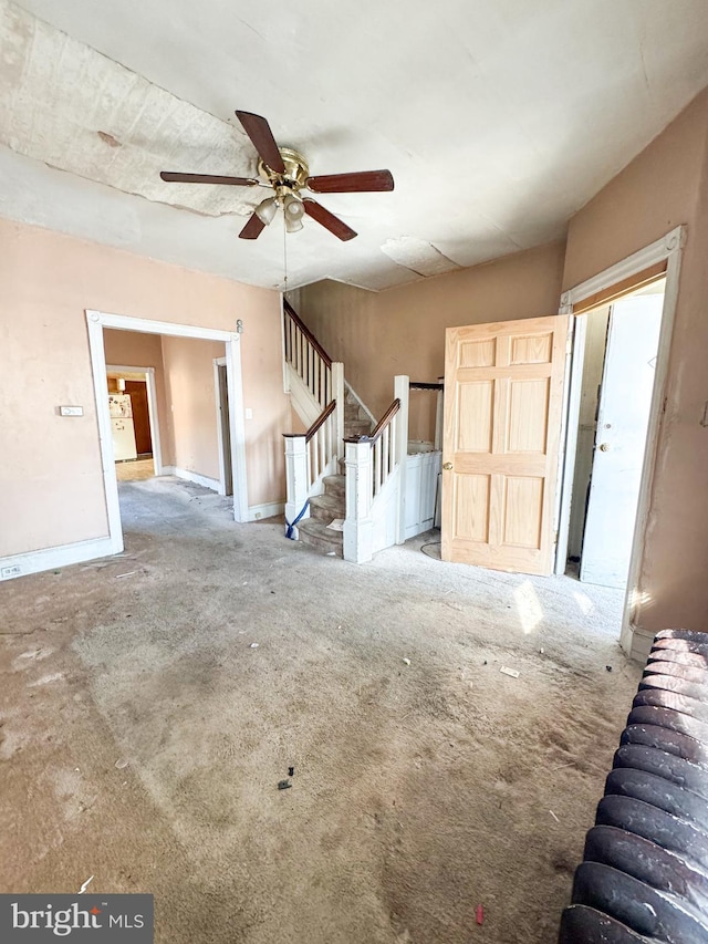 unfurnished living room with ceiling fan