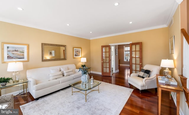 living area with french doors, dark wood-style flooring, visible vents, ornamental molding, and baseboards